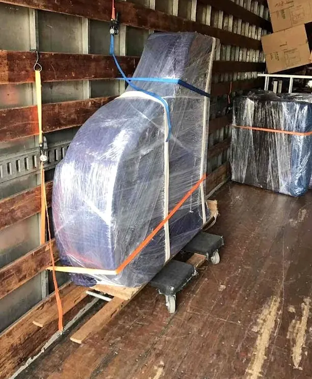 Wrapped and strapped furniture inside a moving truck